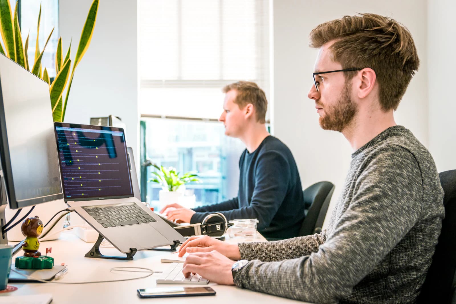 Developers building software on large screens during a project