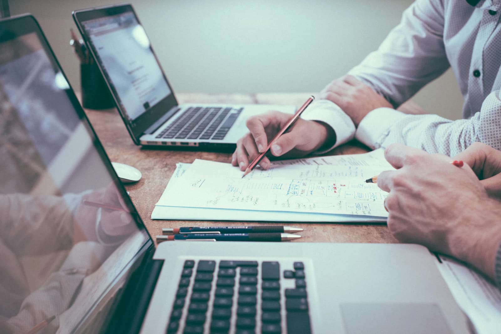 Project consultation — planning a software project with notes and laptop
